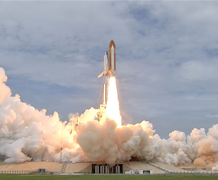 Space shuttle Atlantis lifts off the launch pad.