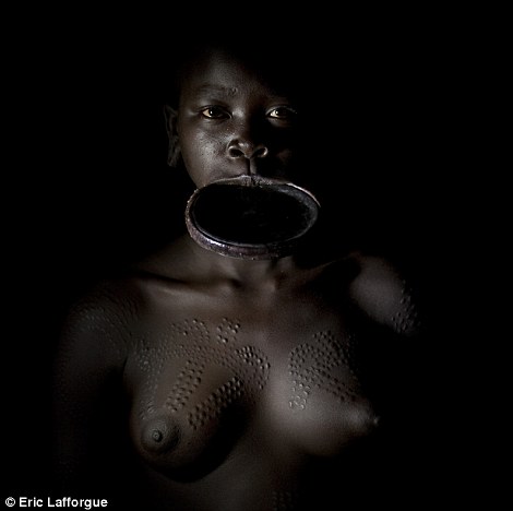 Along with scar patterns, nearly all Surma women wear lip plates